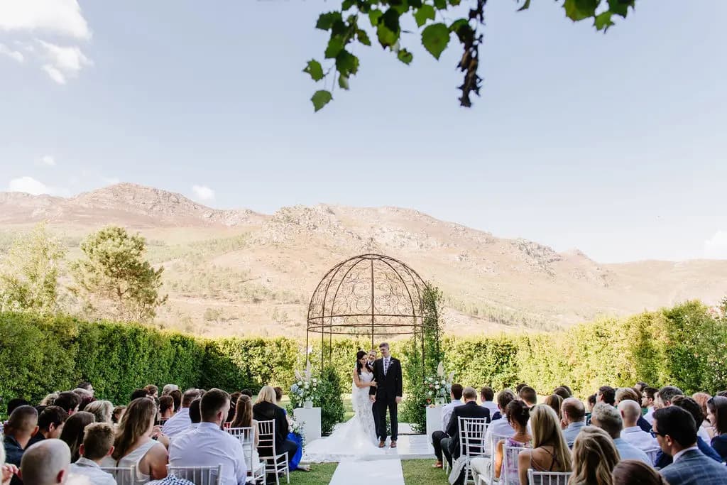 Wedding guests watching ceremony and La Paris famous arch