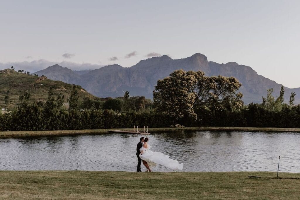 Brides wedding dress blowing in wind at La Paris dam