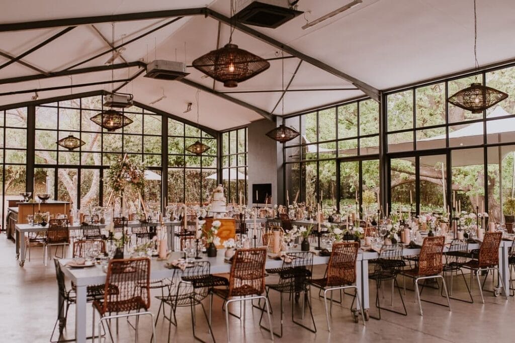 The interior of The Conservatory with seating arranged around a wedding cake in the center.